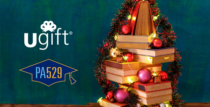 christmas tree made of books with ugift logo and 529 logo